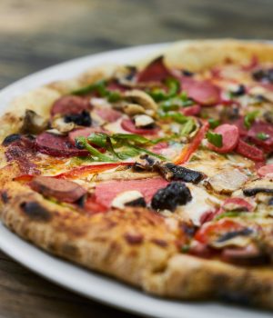 Delicious pizza served on porcelain plate